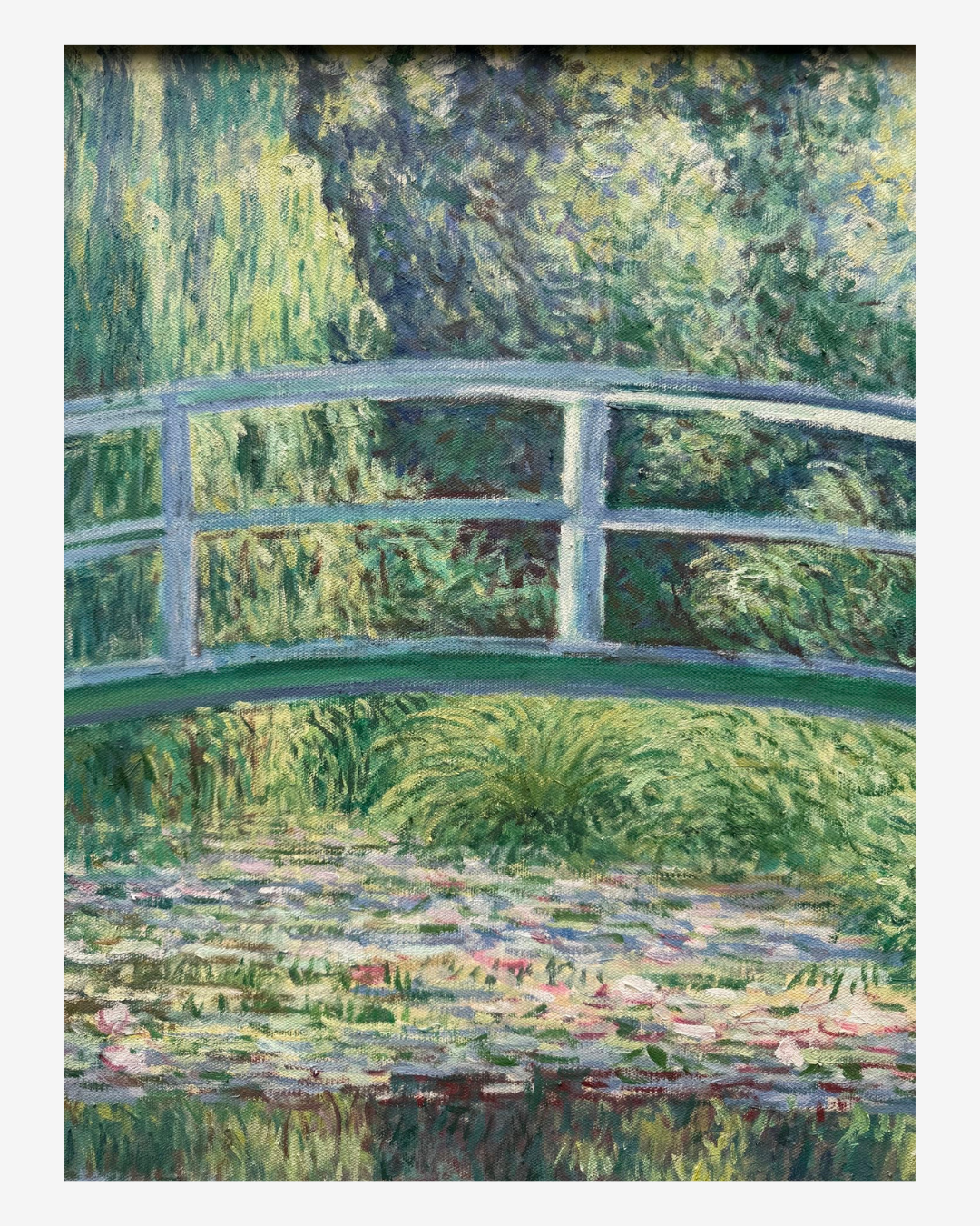 Close-up view of impressionist brushstrokes on Monet The Japanese Footbridge painting, showing the bridge and water lily details